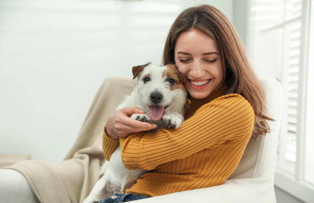 Young woman with her cute Jack Russell Terrier